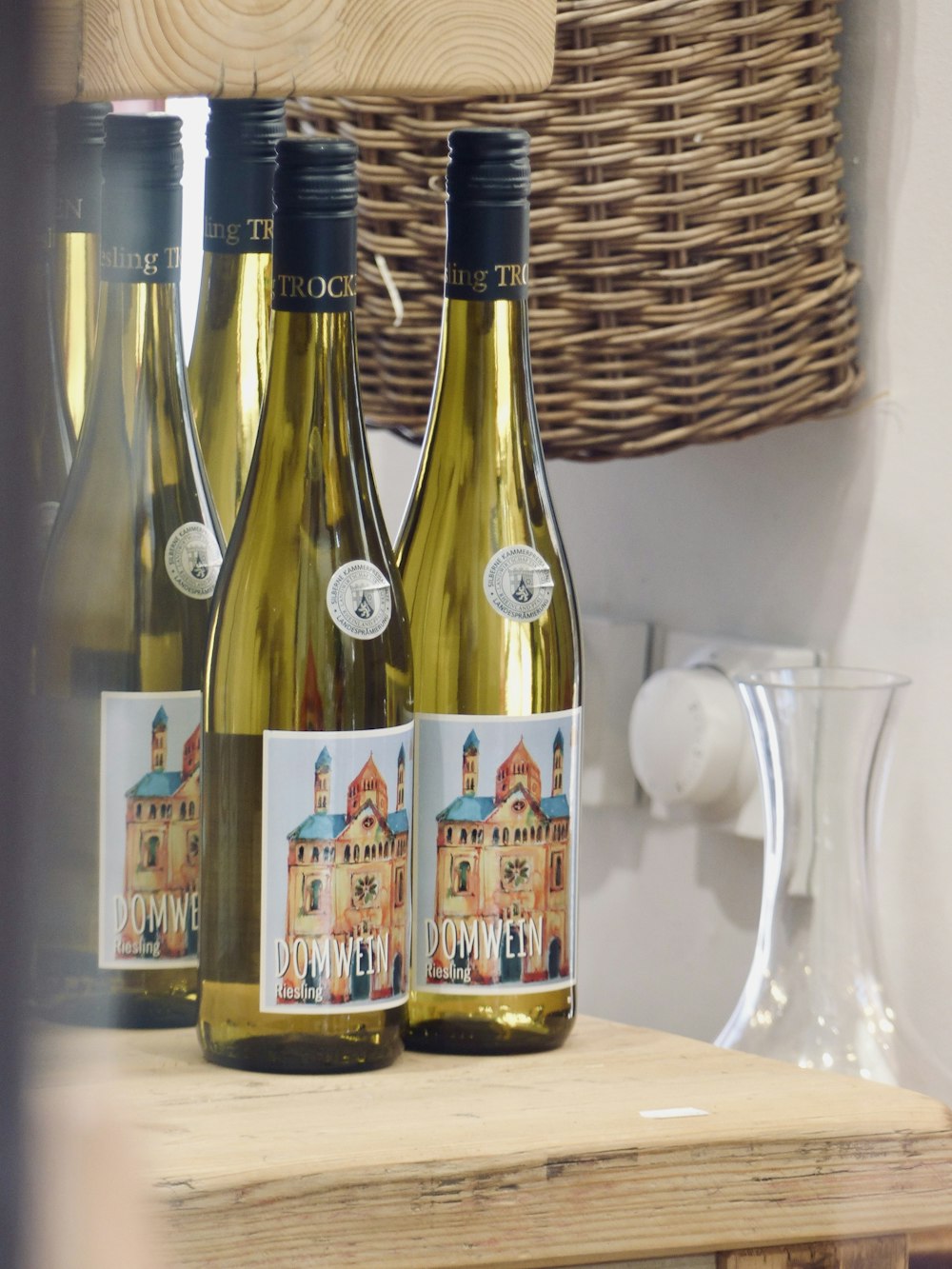 three bottles of wine sitting on top of a wooden table