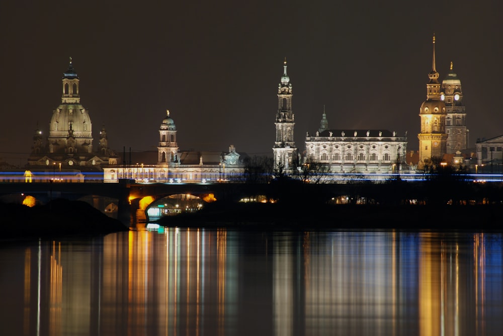 a night view of a city with a bridge over a body of water