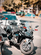A fleet of motorcycles and trucks equipped with GPS devices ready for service.