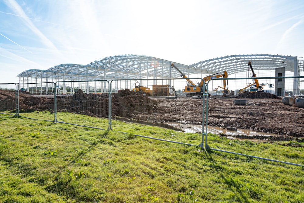 a construction site with a large metal structure in the background