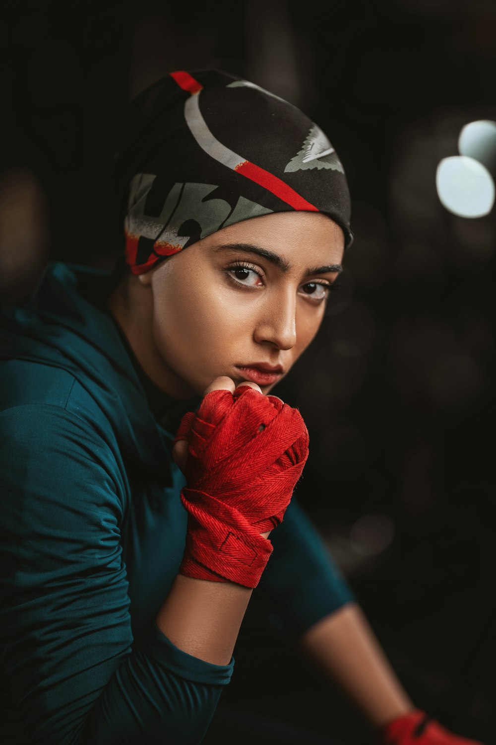 a woman in a green shirt and red gloves