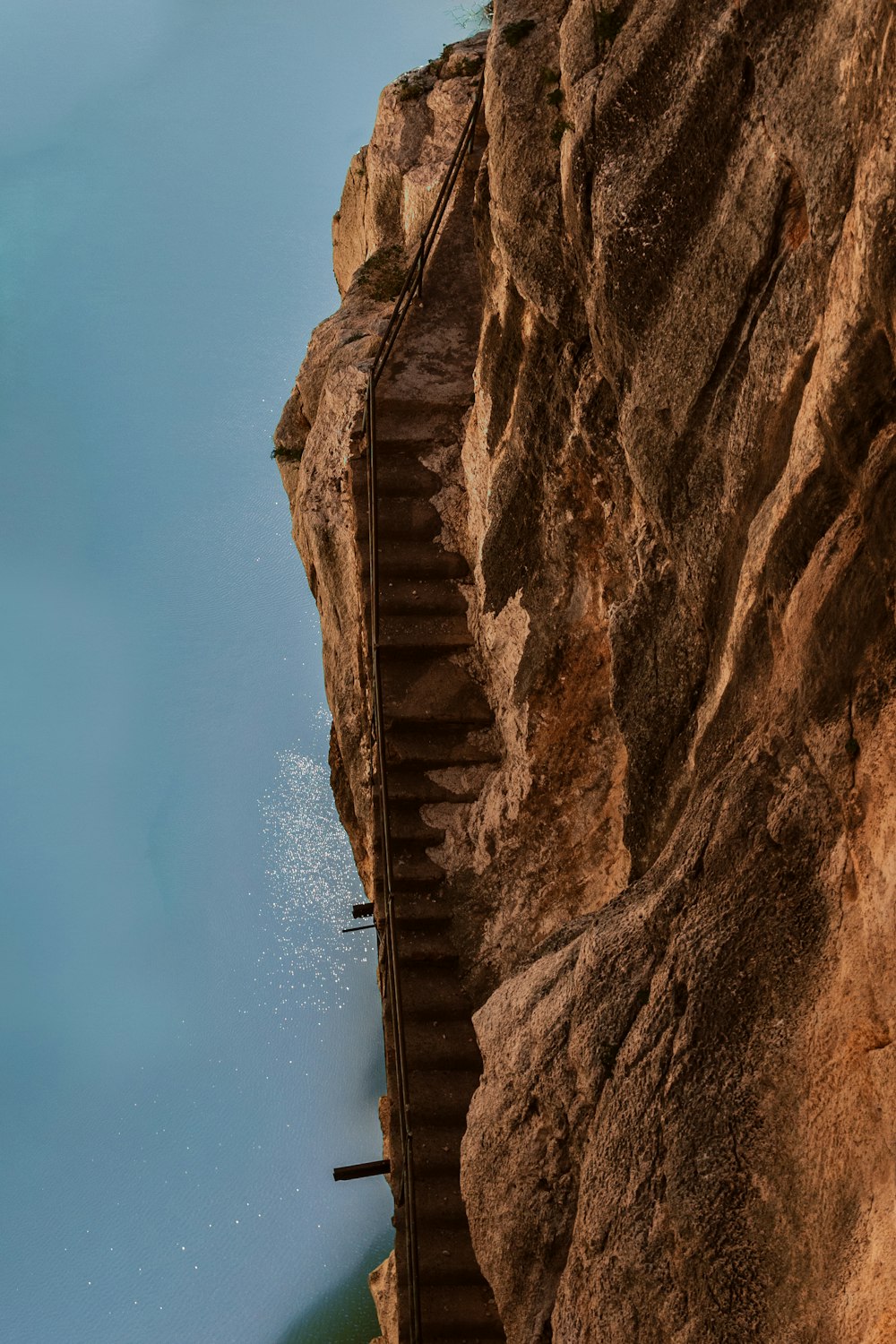 a person jumping off a cliff into a body of water