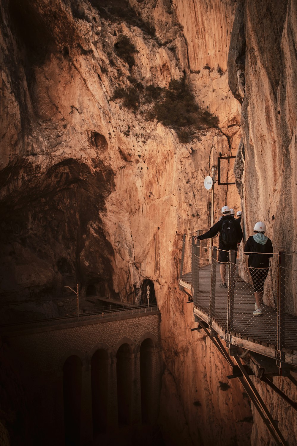 a couple of people that are standing on a bridge