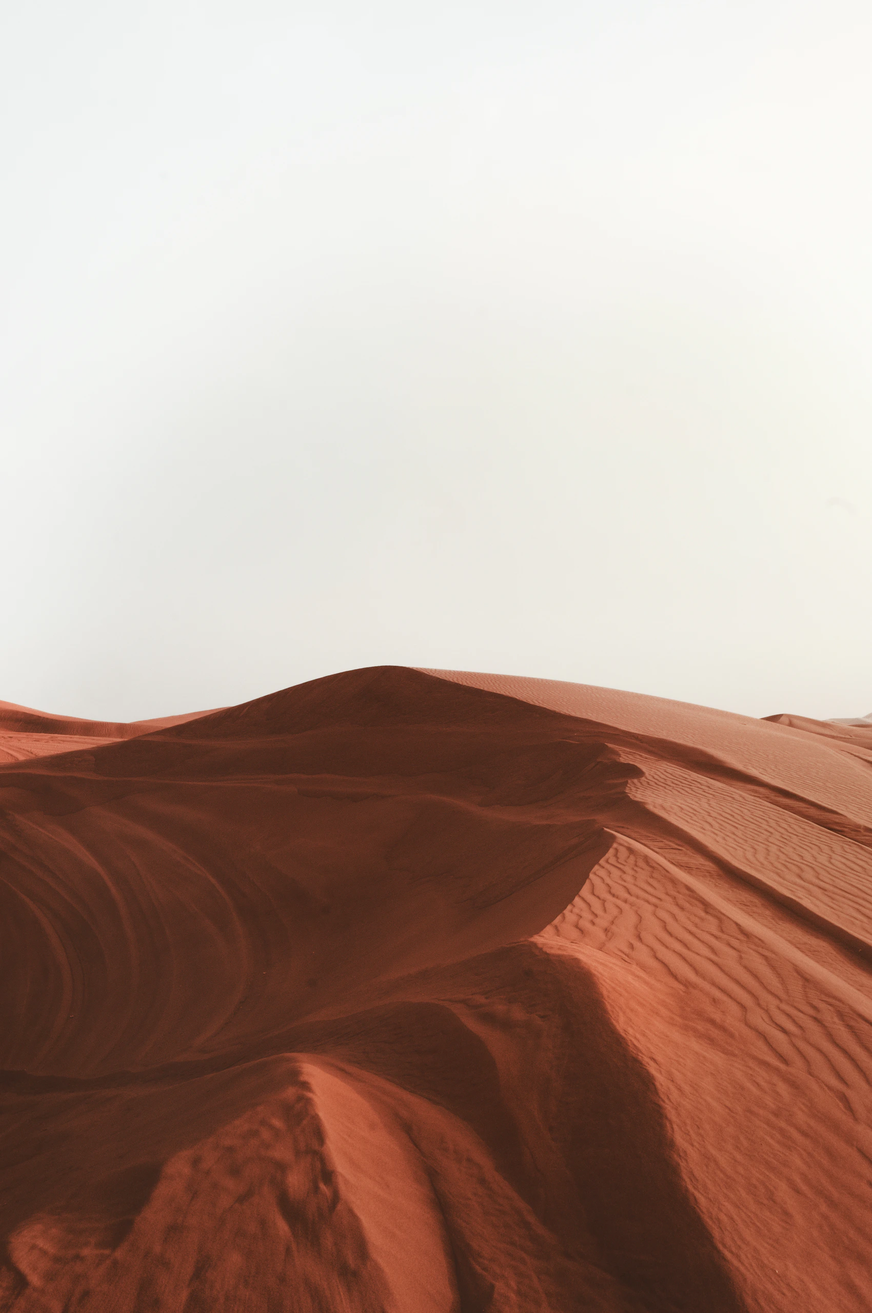 Red sand dunes stretching across the desert outside Dubai