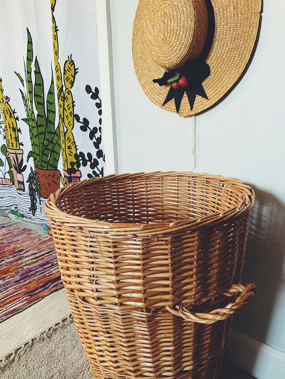 a wicker basket with a hat hanging on the wall
