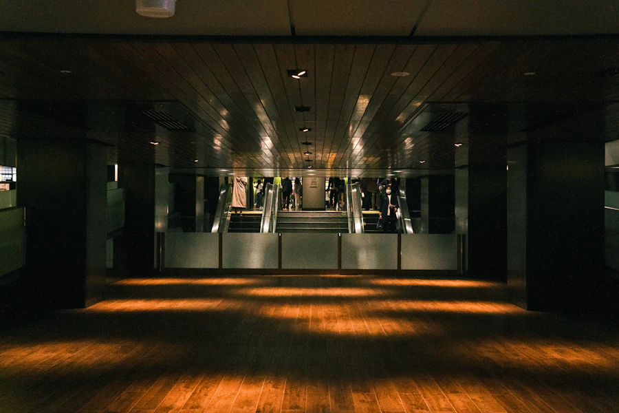 Dance studio interior with hardwood floor, mirrors, and warm track lighting