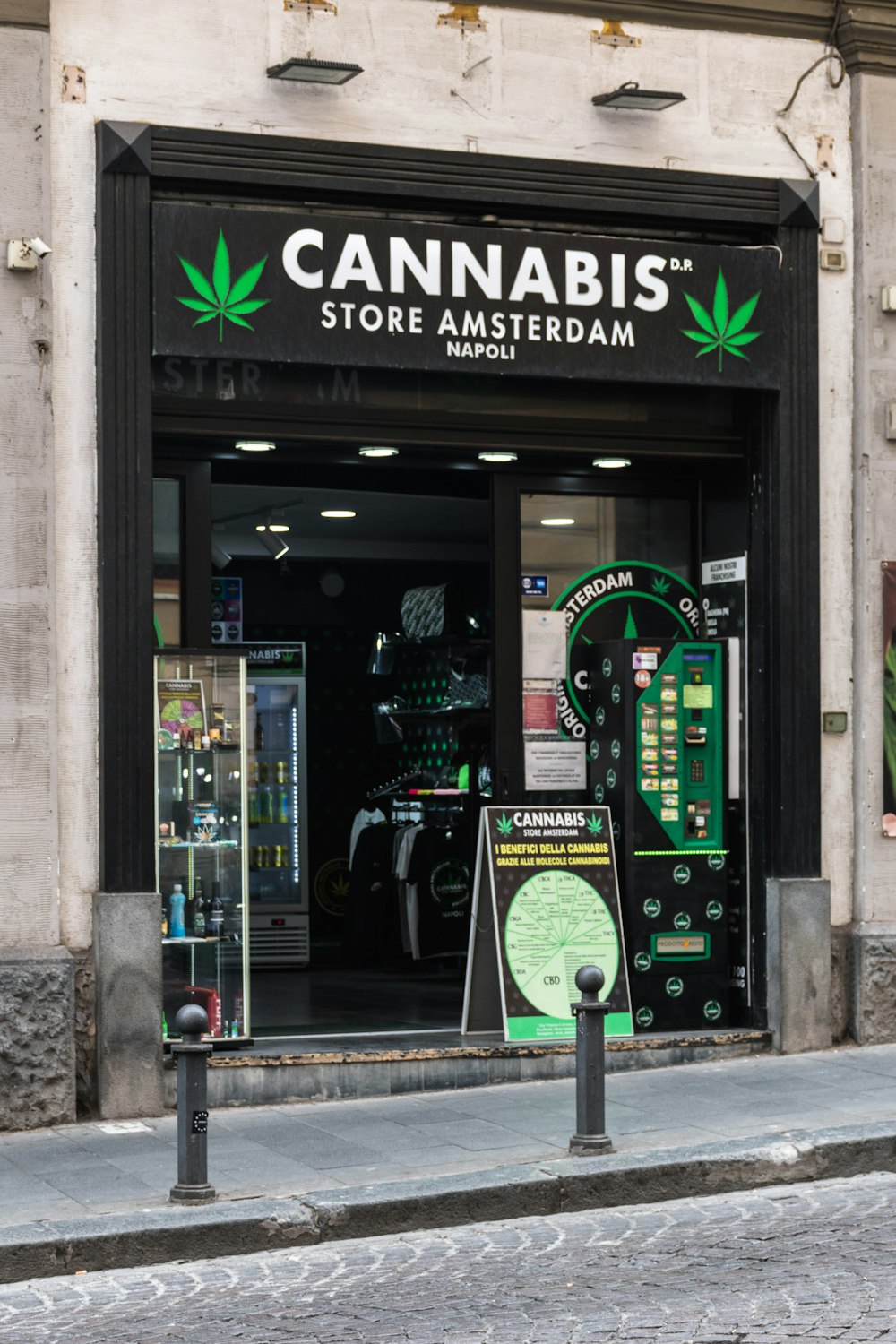 a store front with a green marijuana leaf on it