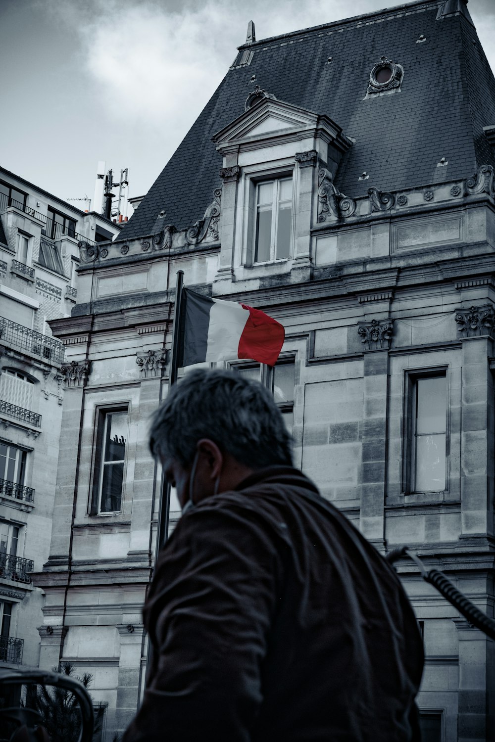 a man standing in front of a tall building