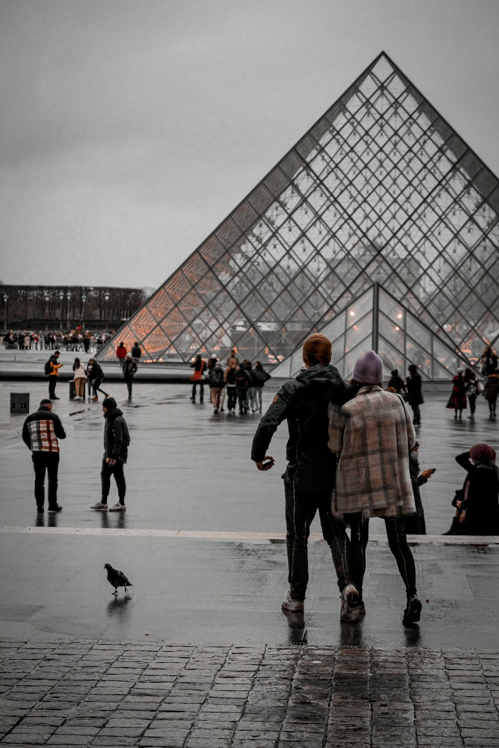 a group of people standing in front of a pyramid