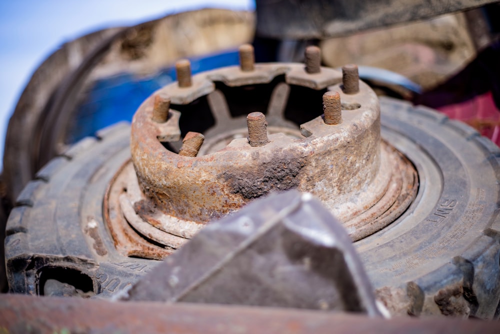 a rusted metal object sitting on top of a pile of junk