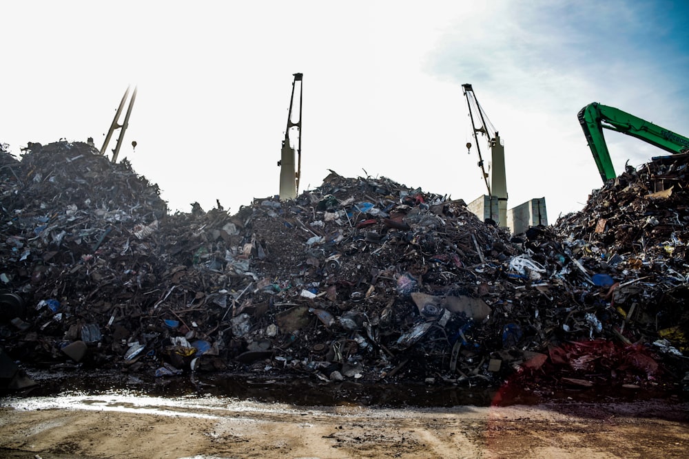 a large pile of trash sitting next to a dump truck