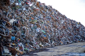 a large pile of trash sitting on the side of a road
