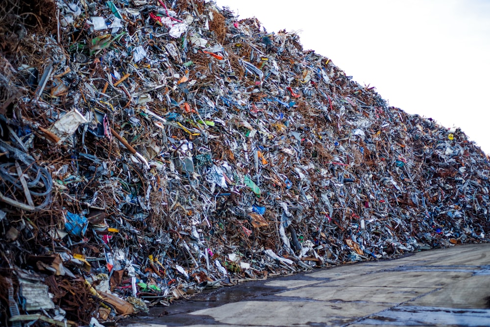 a large pile of trash sitting on the side of a road