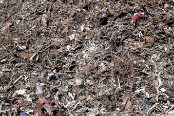 a pile of garbage with a red fire hydrant in the middle of it