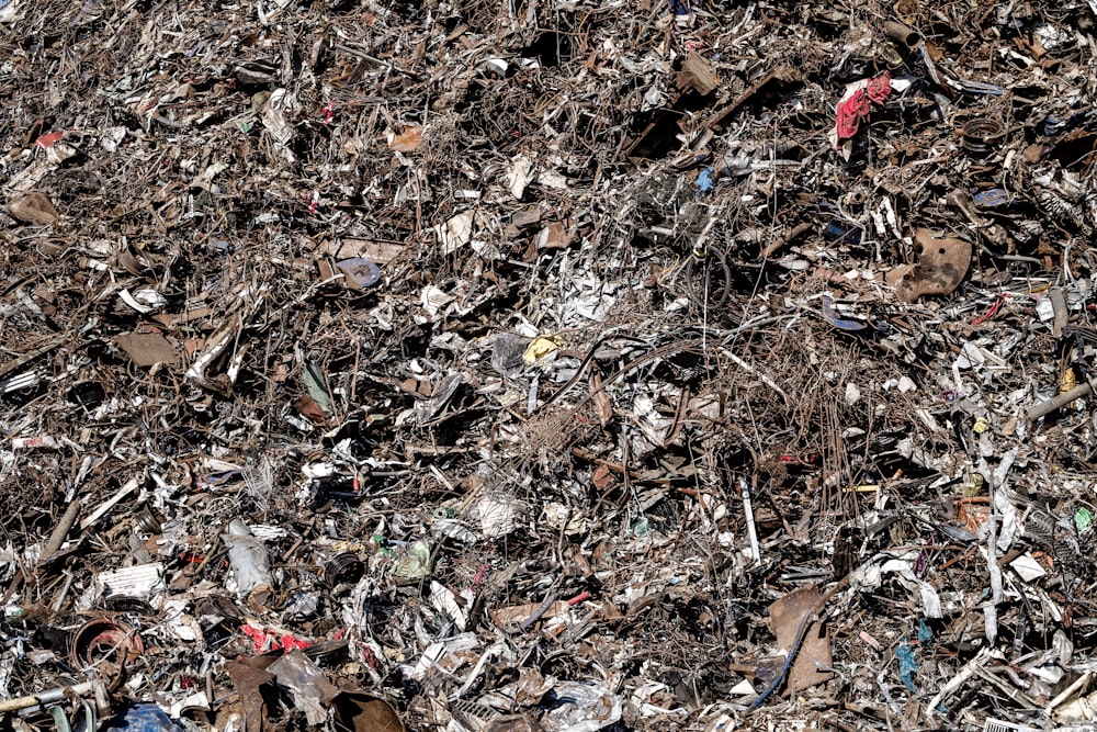 a pile of garbage with a red fire hydrant in the middle of it