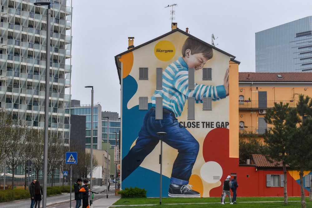 a large mural of a boy on the side of a building