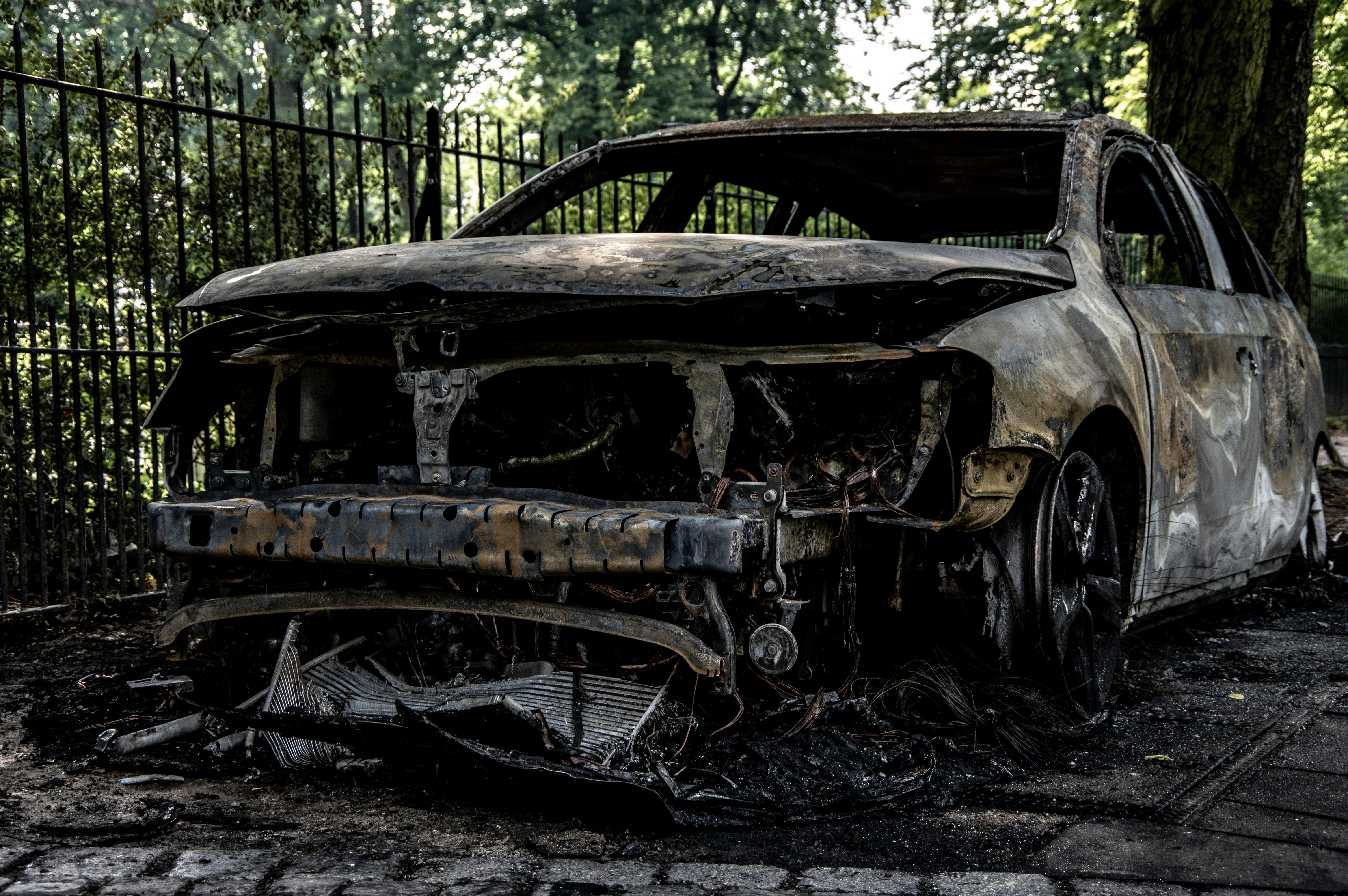 insurance paperwork next to burnt car - does car insurance cover fire damage