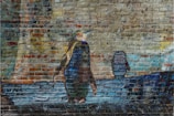 A mural on a brick wall depicts a penguin walking alongside a body of water. The background consists of abstract and blurred images creating an urban and artistic vibe.