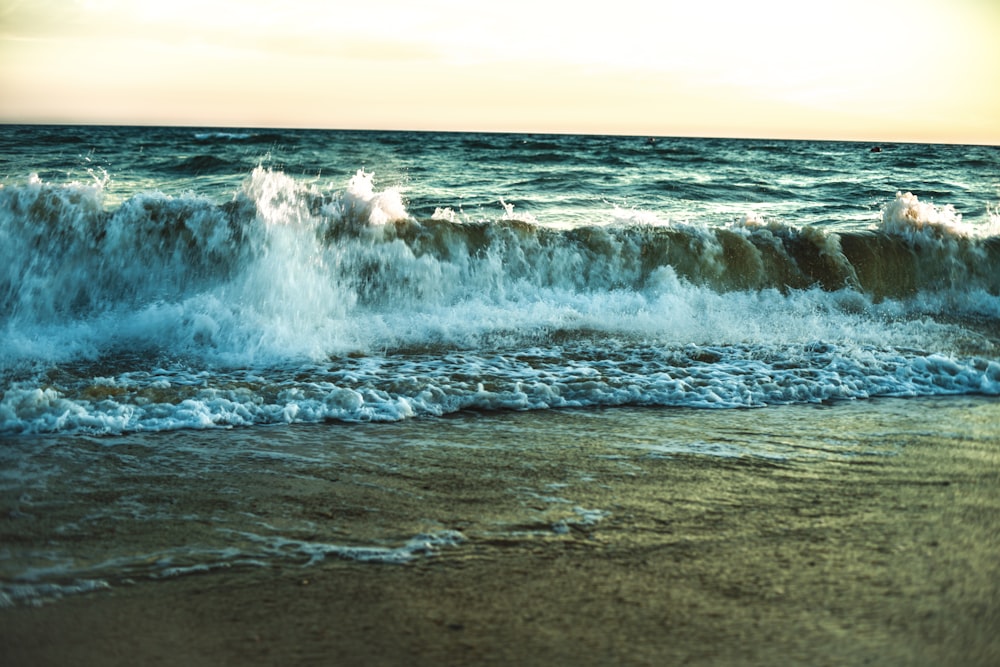 a large body of water sitting next to a sandy beach