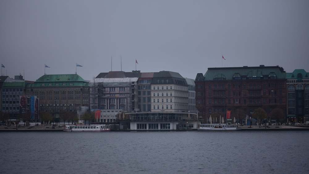 a body of water with buildings in the background