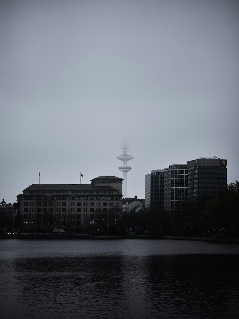 a body of water with buildings in the background