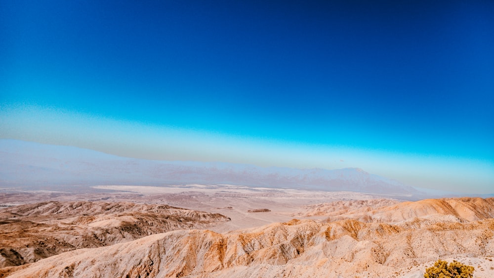 a view of a mountain range with a blue sky in the background