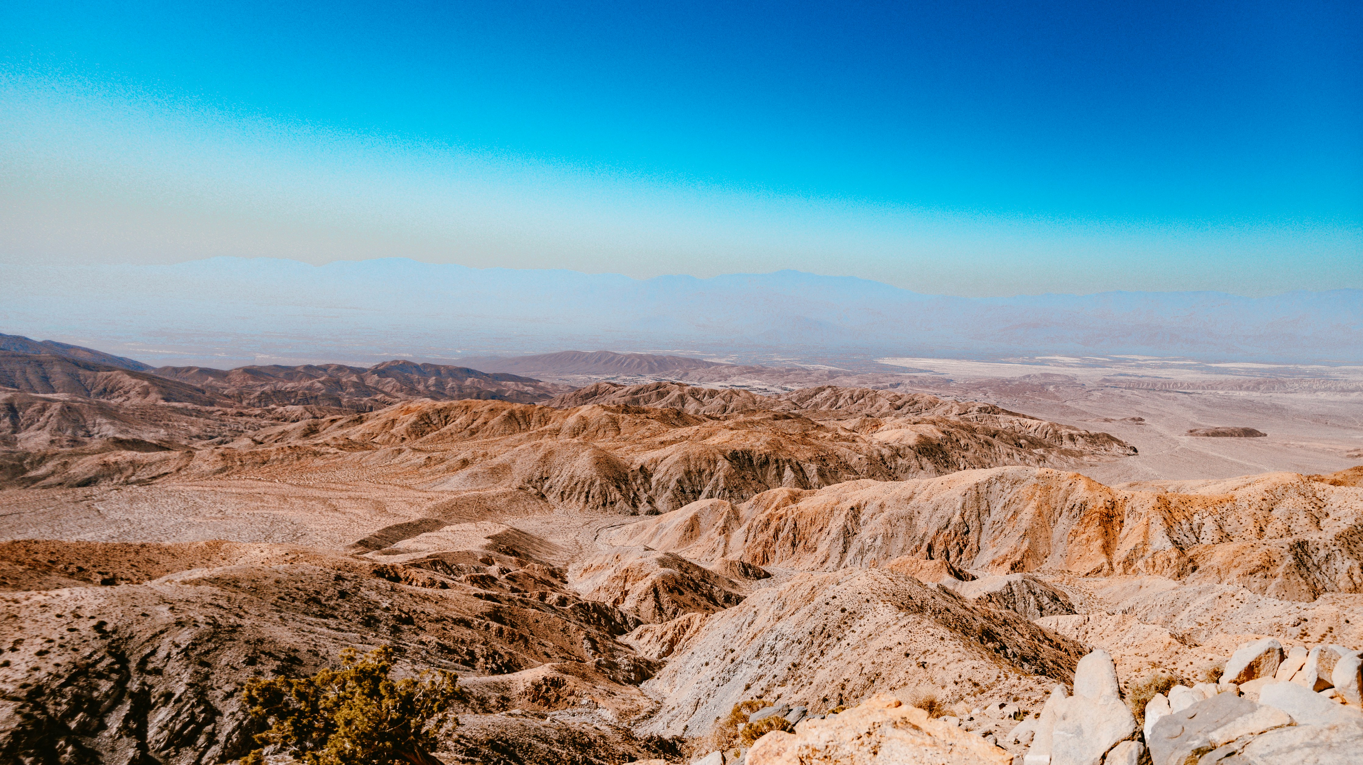 a view of a desert with mountains in the distance