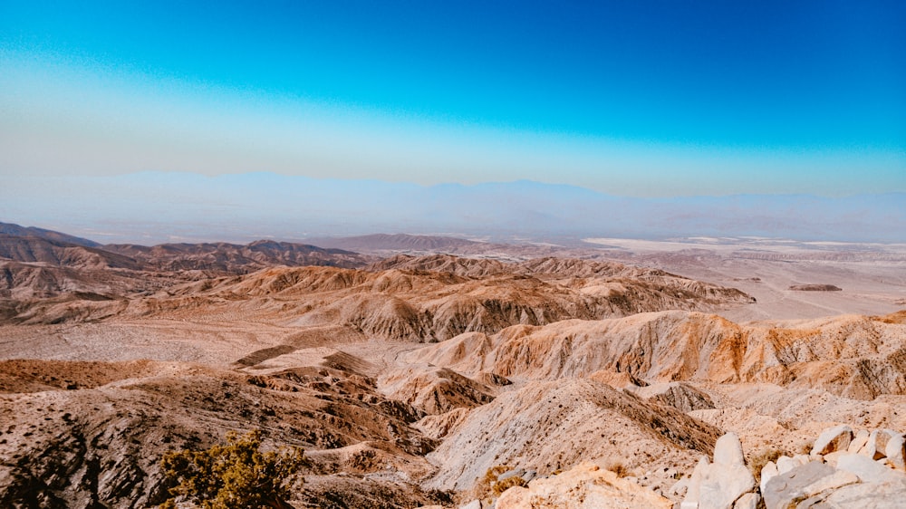 a view of a desert with mountains in the distance