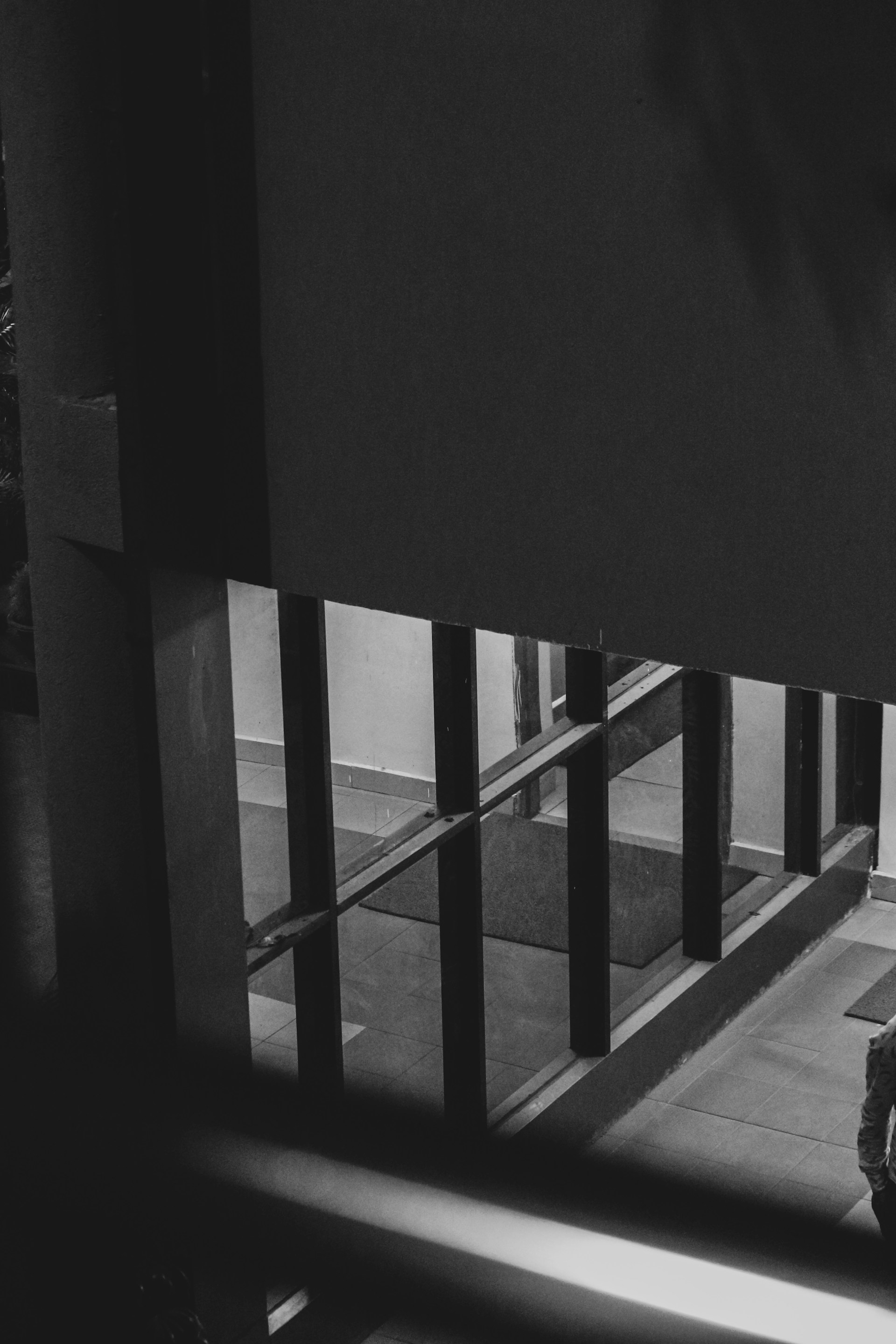 a black and white photo of a motorcycle parked in front of a building