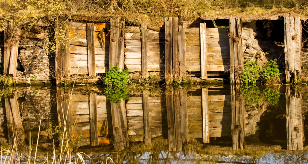 an old wooden building sitting next to a body of water
