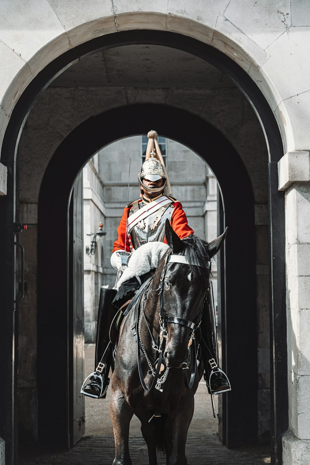 a man riding on the back of a brown horse