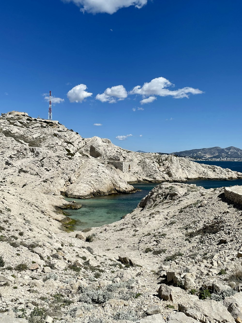 a body of water sitting on top of a rocky hillside