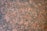 A detailed, intricate pattern of speckled granite stone with a mix of pinkish-brown and dark gray hues, featuring a naturally textured surface.