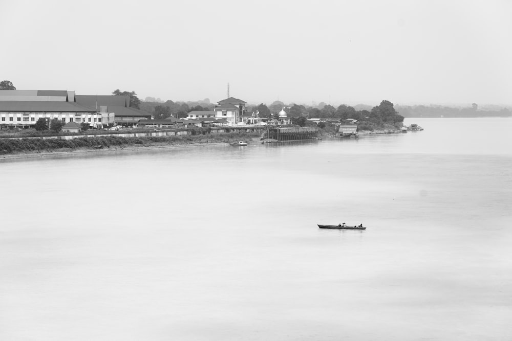 a black and white photo of a boat in the water