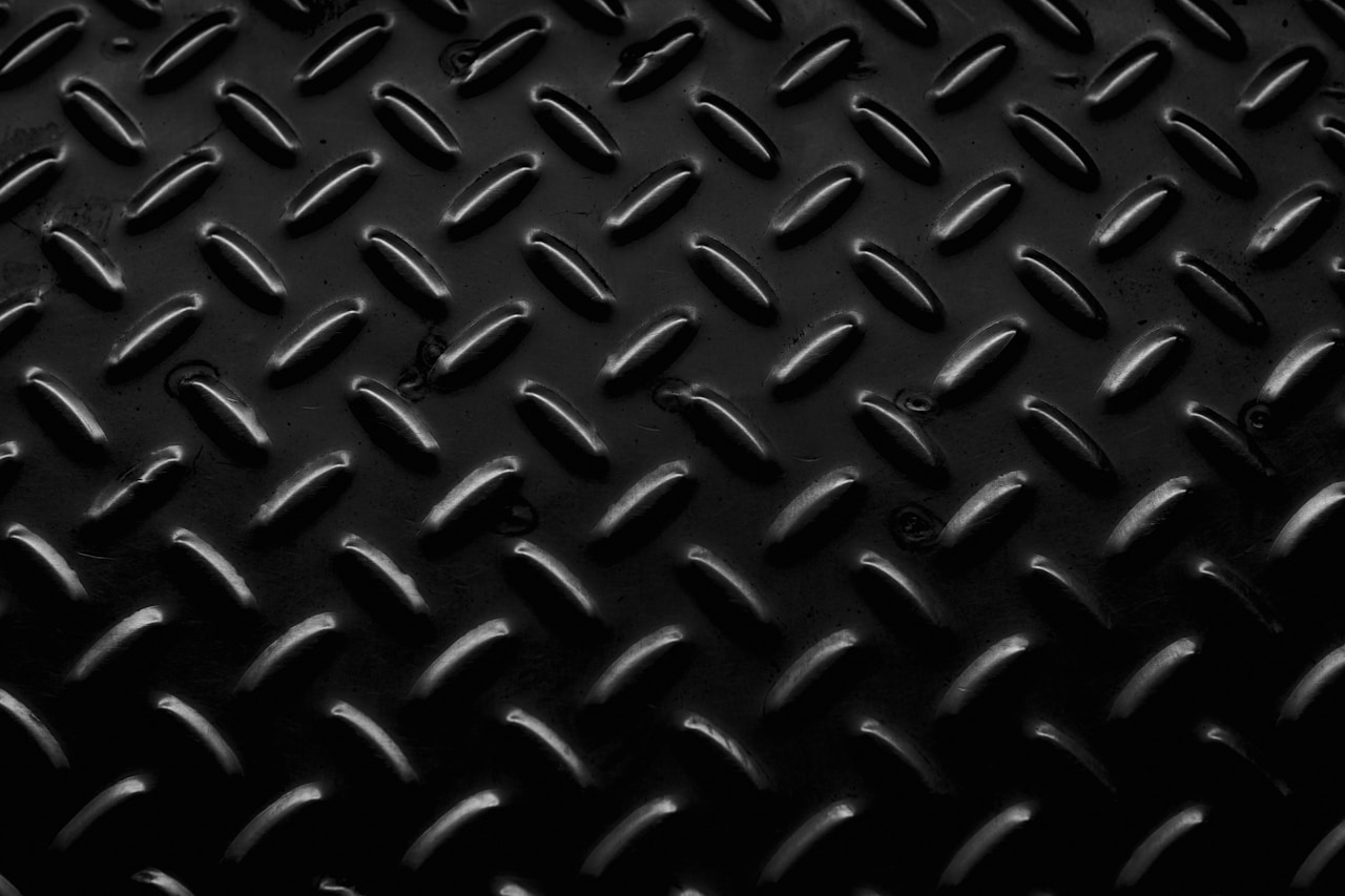dark forged metal surface, the kind of hard metal that takes wedding ring engraving by laser