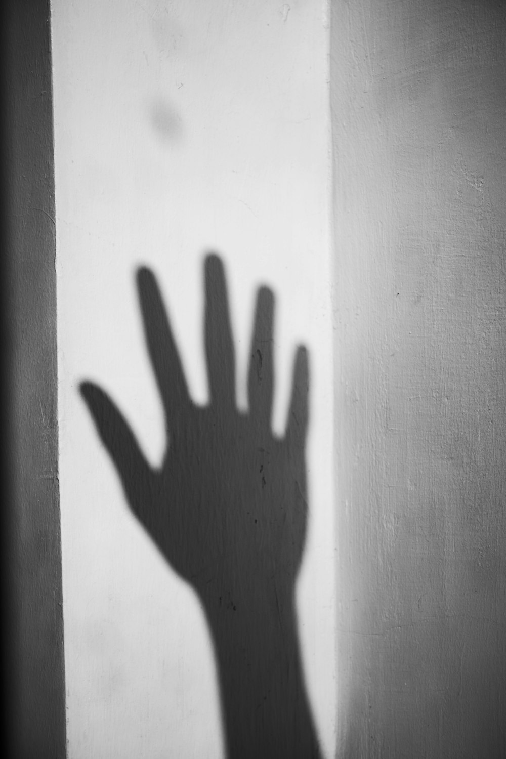 a shadow of a hand on a wall