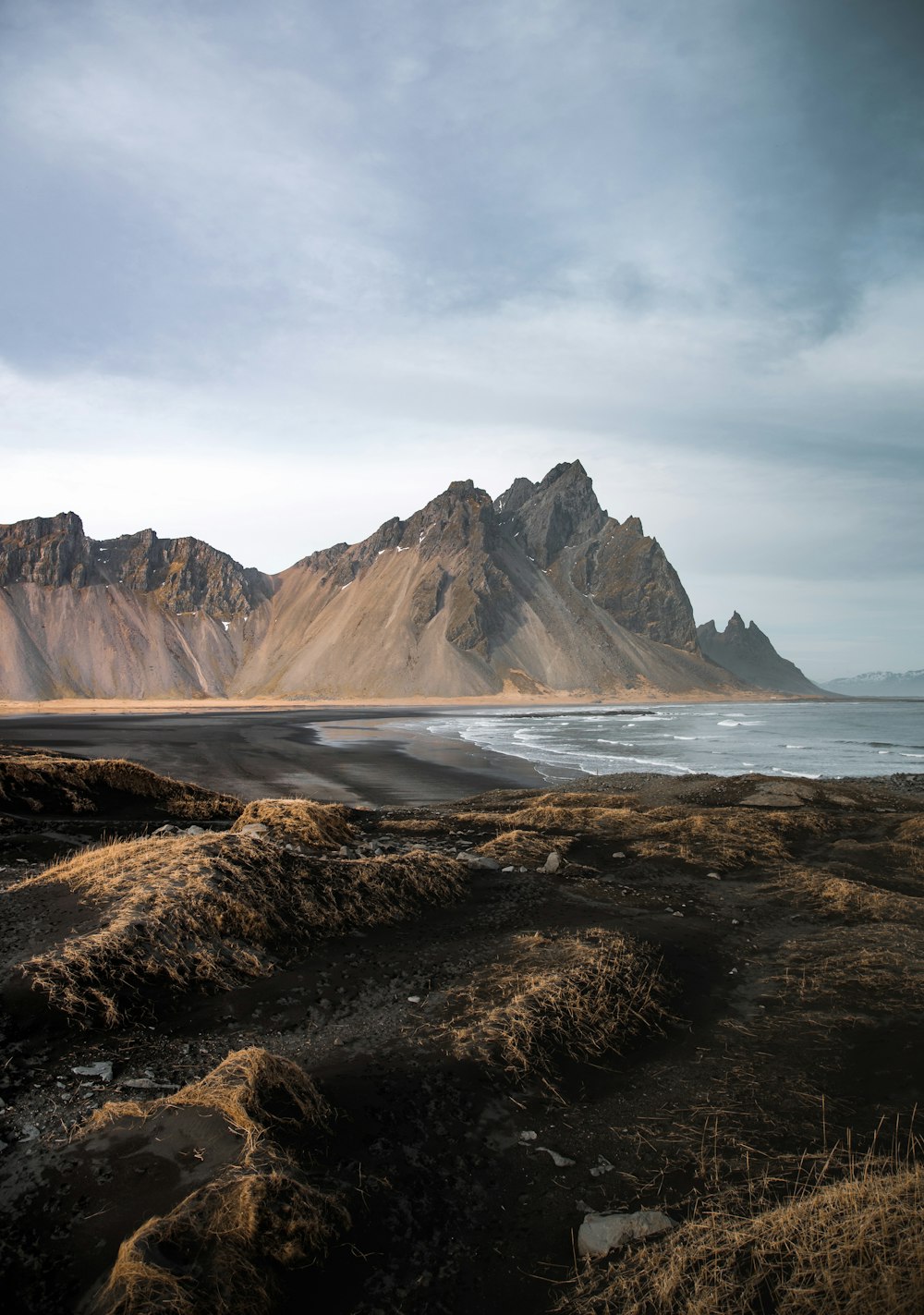 a mountain range with a body of water in the foreground