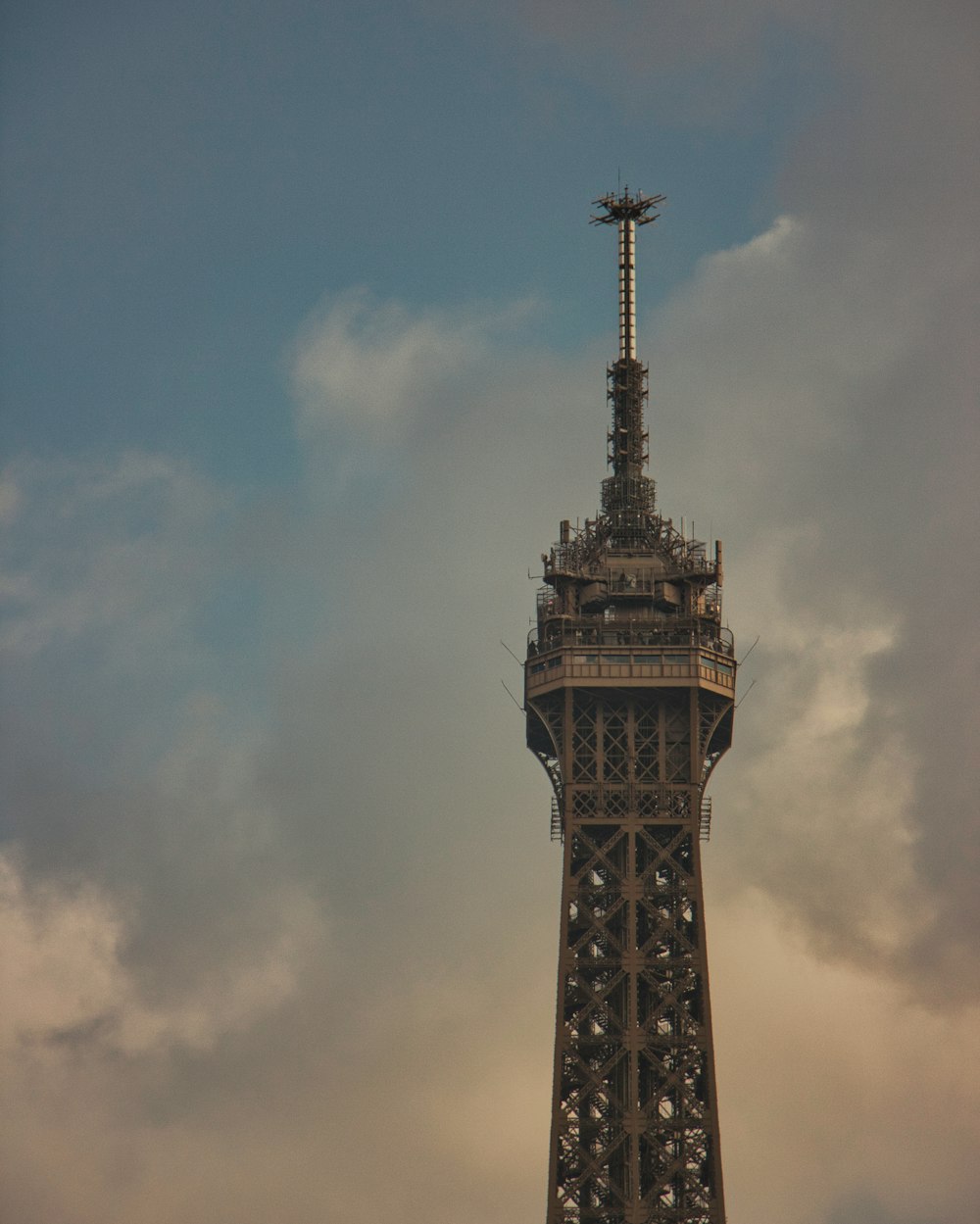 a tall tower with a cross on top of it