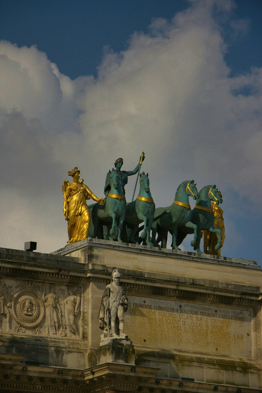 a statue on top of a building with a sky background
