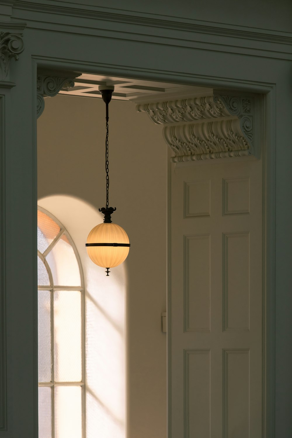 a light hanging from a ceiling in a room