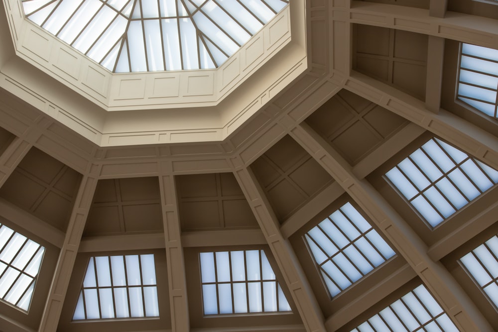 the ceiling of a building with many windows