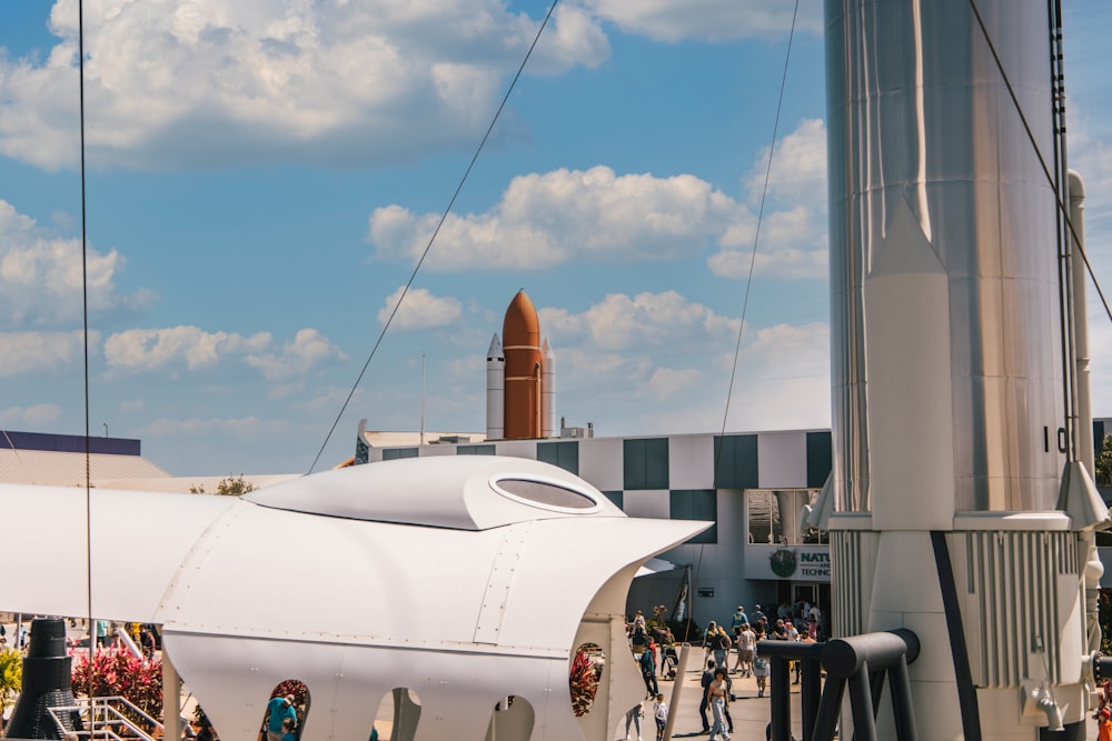 a group of people standing around a white airplane