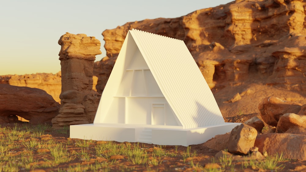 a model of a building in the middle of a desert