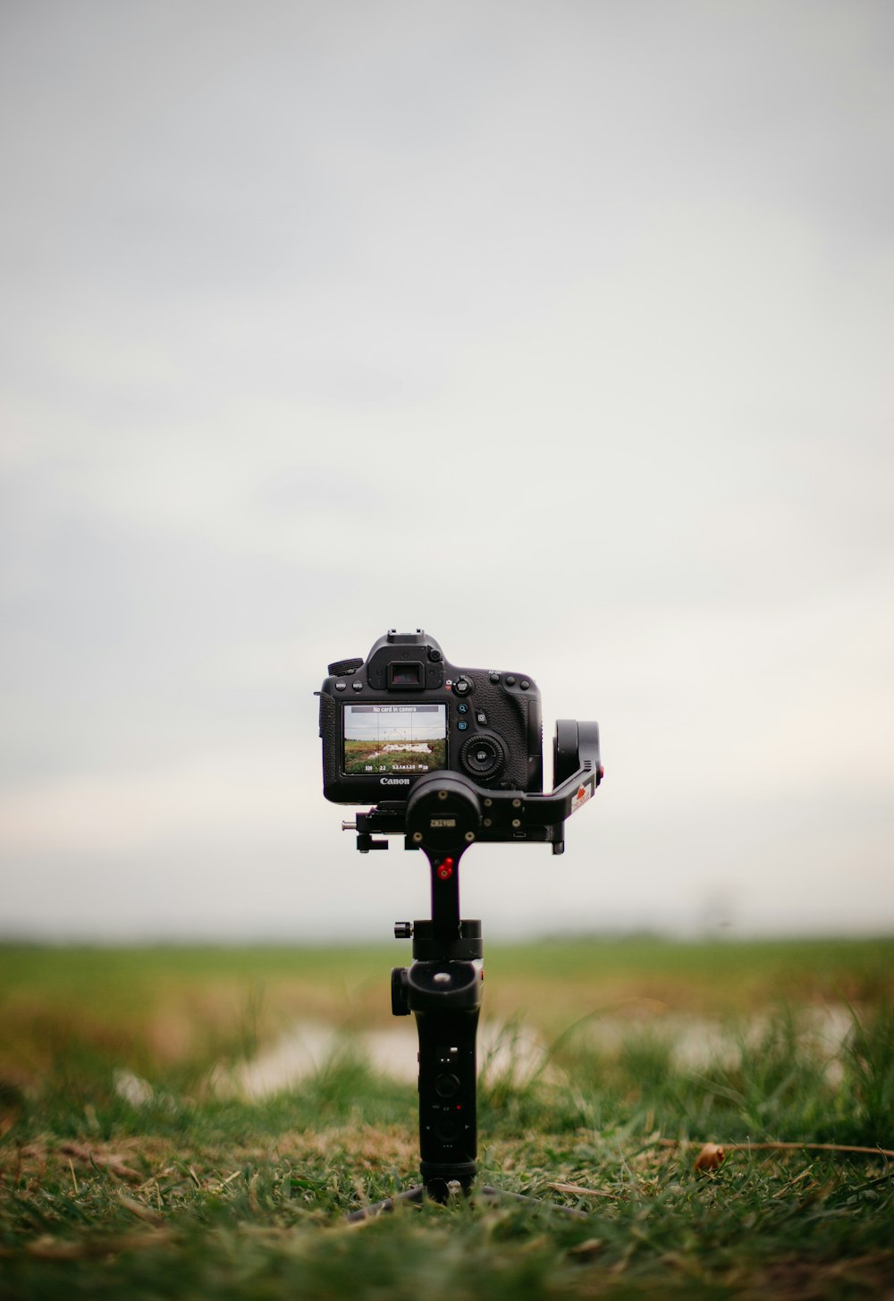 a camera on a tripod in a field