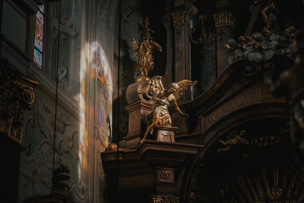 a statue of an angel on a pedestal in a church