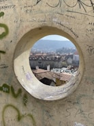 a hole in a wall with graffiti on it