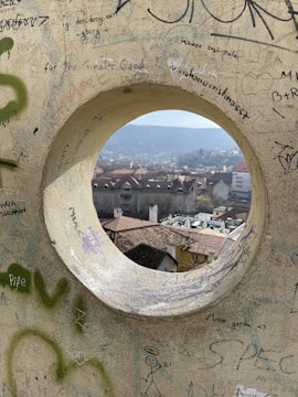 a hole in a wall with graffiti on it