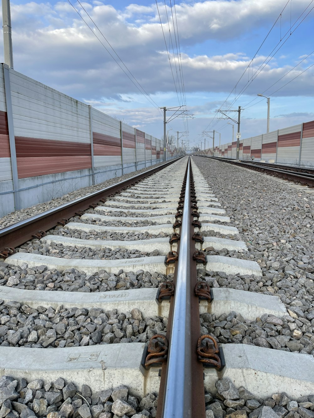 a train track with a sky in the background