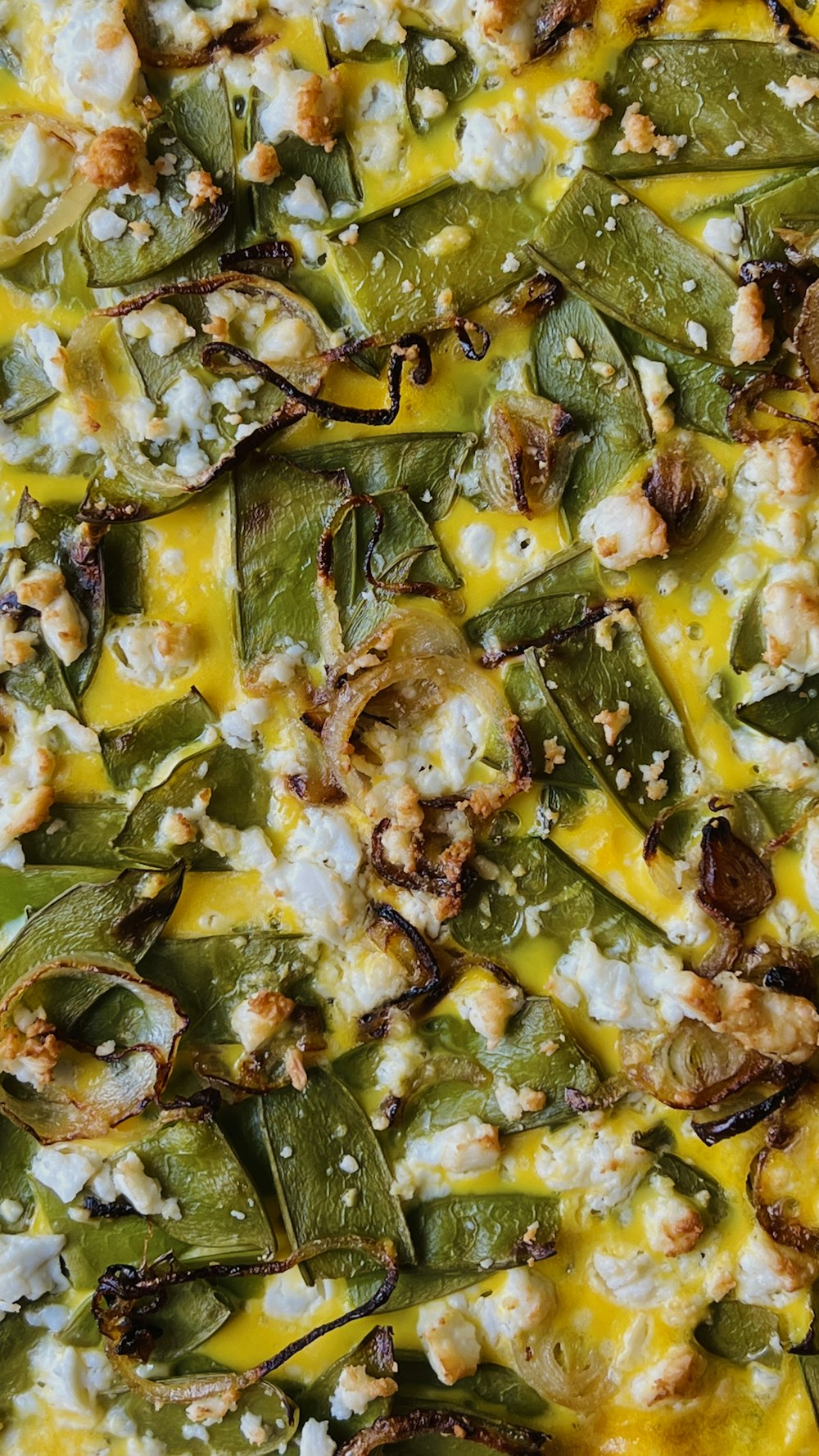 a pizza with cheese, green peppers, and other toppings