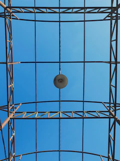 Finished steel framework ready for installation, highlighted by industrial lighting.